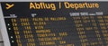 Airport flight information on a large screen international departure board