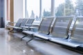 Airport gate waiting area with metal seats Royalty Free Stock Photo