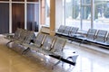 Airport gate waiting area with metal seats Royalty Free Stock Photo