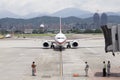 Airport ground service await aircraft approaching with jet brid