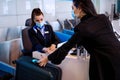 Airport ground staff sits at the counter, weighing luggage and registration Royalty Free Stock Photo