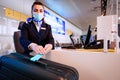 Airport ground stafft sits at the counter, weighing luggage and registration Royalty Free Stock Photo