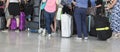 Airport luggage Trolley with suitcases, unidentified man woman walking in the airport, station, France.