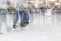 Airport luggage Trolley with suitcases, unidentified man woman walking in the airport, station, France. Blur motion, double exposu Royalty Free Stock Photo