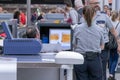 Airport, palma, mallorca, spain, 2019 april 14: Man in uniform standing at counter at checking point and watching at monitor with Royalty Free Stock Photo