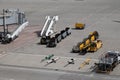 Airport passenger stairs and baggage carts pushrods Royalty Free Stock Photo