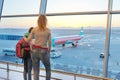 Airport passengers family mother and daughter child looking at planes in panoramic window Royalty Free Stock Photo