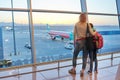 Airport passengers family mother and daughter child looking at planes in panoramic window Royalty Free Stock Photo