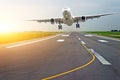 Airport runway airplanes with traces of rubber tires at dawn in the morning with sun glare. Royalty Free Stock Photo