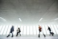 Airport rush: people with their suitcases walking along a corridor Royalty Free Stock Photo