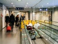 Airport scene with workers from Schindler moving walkway