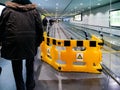 Airport scene with workers from ThyssenKrupp moving walkway