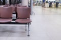 Airport seat in waiting area and wayfinding signage. Royalty Free Stock Photo