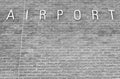 Airport sign on a brick background