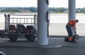Airport staff collecting fallen luggage