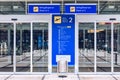 Airport terminal building gate entrance and automatic glass door with info text in german and english. Modern airport glass wall Royalty Free Stock Photo