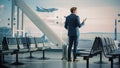 Airport Terminal: Businessman with Rolling Suitcase Walks, Uses Smartphone App for e-Business. Bac Royalty Free Stock Photo