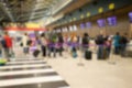 Airport terminal check-in counter with passengers hall blurred background Royalty Free Stock Photo