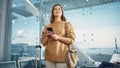 Airport Terminal: Happy Traveling Caucasian Woman Waiting at Flight Gates for Plane Boarding, Uses Royalty Free Stock Photo