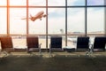 Airport terminal interior with empty seats, background a flying Royalty Free Stock Photo