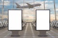 Airport terminal lounge. Two blank billboard stands and airplane on background. Royalty Free Stock Photo