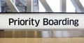 Airport PRIORITY BOARDING sign.