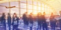 Motion blur of people in airport terminal at sunset with passengers Royalty Free Stock Photo