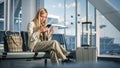 Airport Terminal: Woman Waits for Flight, Uses Smartphone, Receives Shockingly Bad News, Starts Cr Royalty Free Stock Photo