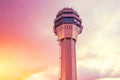 Airport traffic control tower lonely with background of the sunset orange pink light sky and clouds Royalty Free Stock Photo