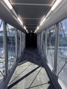 Airport Tunnel. Airplane bridge. Walking down the corridor walkway to aircraft.