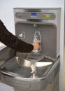 Airport water bottle fill station in use Royalty Free Stock Photo
