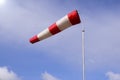 Airport windsock on clear blue sky background in windy weather indicate the local wind direction also called: air sock, drogue, Royalty Free Stock Photo