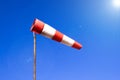 Airport windsock on clear blue sky background in windy weather indicate the local wind direction also called: air sock, drogue, Royalty Free Stock Photo