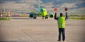 Airport worker signaling