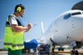 Airport worker writing information on clipboard