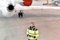 Airport workers check an aircraft for safety in a hangar