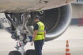 Airport workers check the plane before takeoff