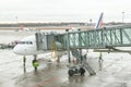 Airport workers (crew) are preparing for disembarking passenger.