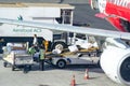 Airport workers loading catering supplies into aircraft