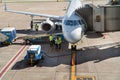 Airport workers a round white airplane in the airport before departure in Buenos aires Argentina