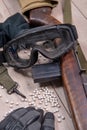 Airsoft gun with protective glasses and lot of bullets Royalty Free Stock Photo