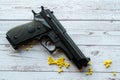 airsoft handgun with yellow bb, on white wooden background