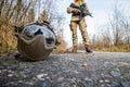 Airsoft helmet on the ground and a girl in military uniform in the background