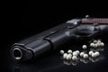 Airsoft pistol with bb bullets on black glossy surface Royalty Free Stock Photo