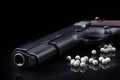 Airsoft pistol with bb bullets on black glossy surface