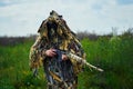 Airsoft player dressed in military uniform with sniper rifle