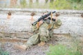 Airsoft player reloads his weapon during a firefight. Royalty Free Stock Photo