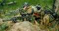 Airsoft sniper men with guns lay on hill. Sniper and aimer on operation Royalty Free Stock Photo