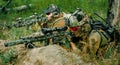 Airsoft sniper men with guns lay on hill. Sniper and aimer on operation Royalty Free Stock Photo