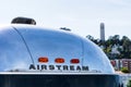 Airstream sign on vintage rounded and polished aluminum camping trailer